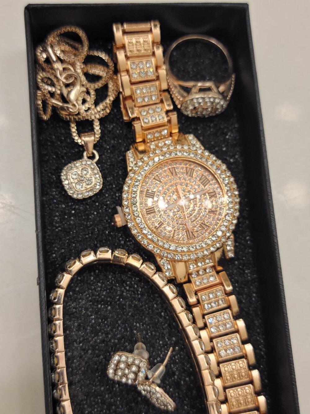 Set of Jewelry Including a Golden Watch, Ring, Necklace, Earrings